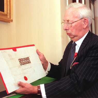 Charles Goodwyn, Keeper of the Royal Philatelic Collection, with copies of world's first stamp