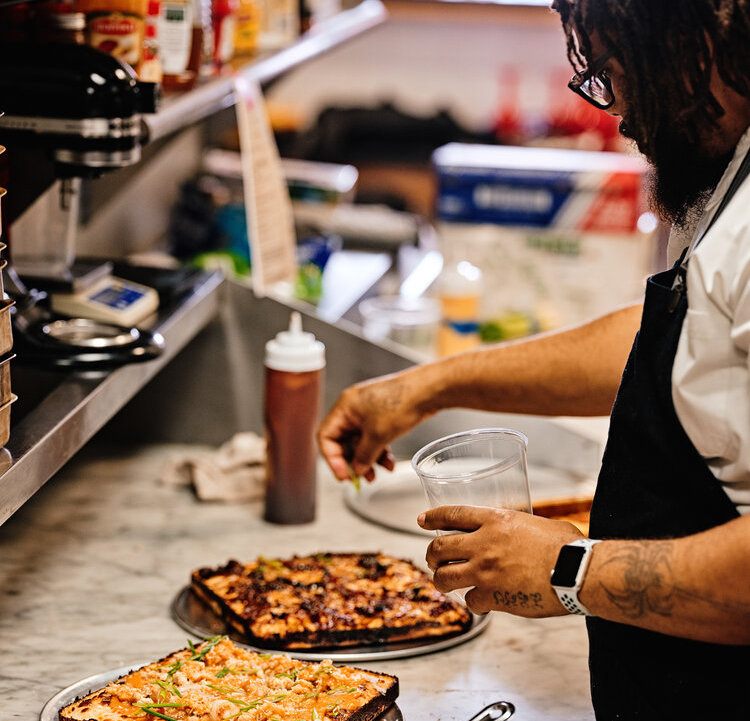 Chef Evans prepares one of his Detroit-style pizzas.