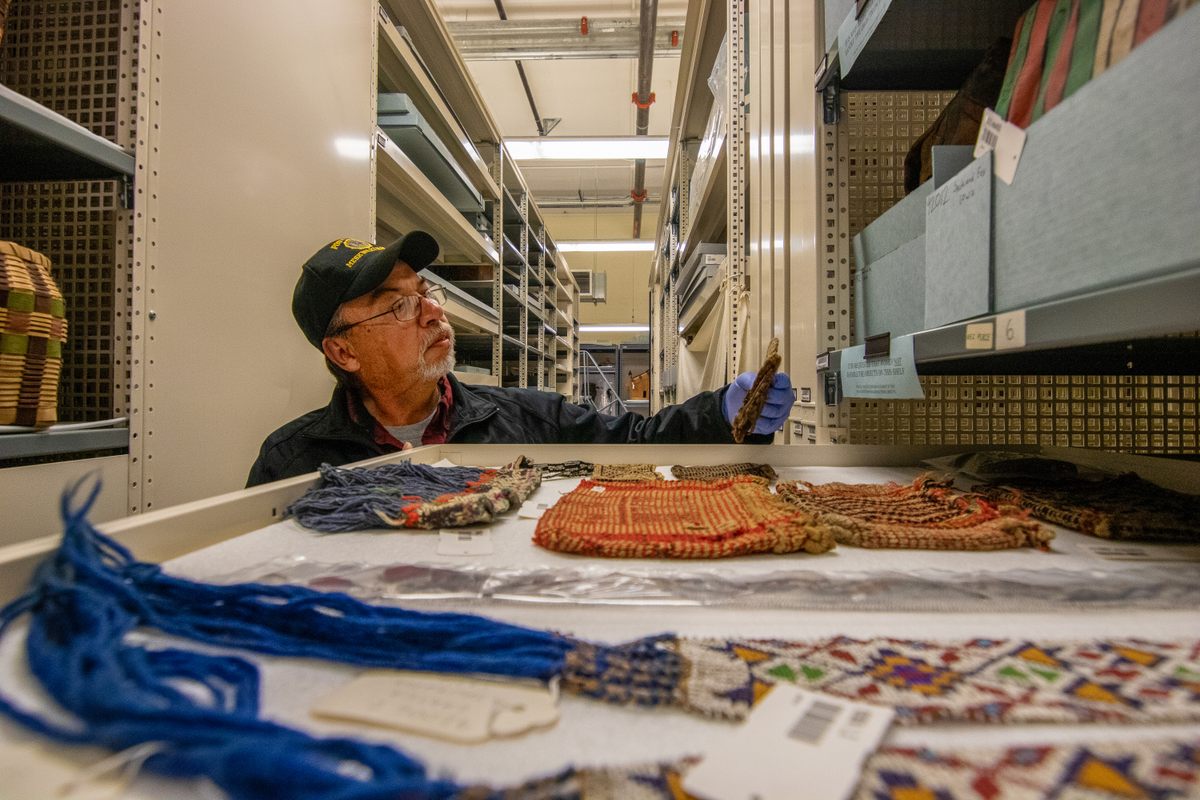 Luke Kapayou looks at Meskwaki objects at the Field Museum.