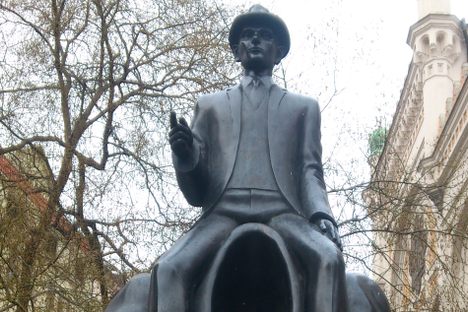 Statue of Franz Kafka with headphones for size comparison.