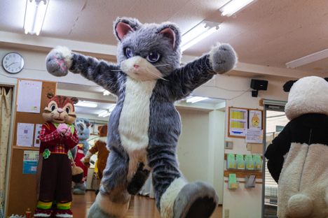 A mascot-in-training jumps for joy.