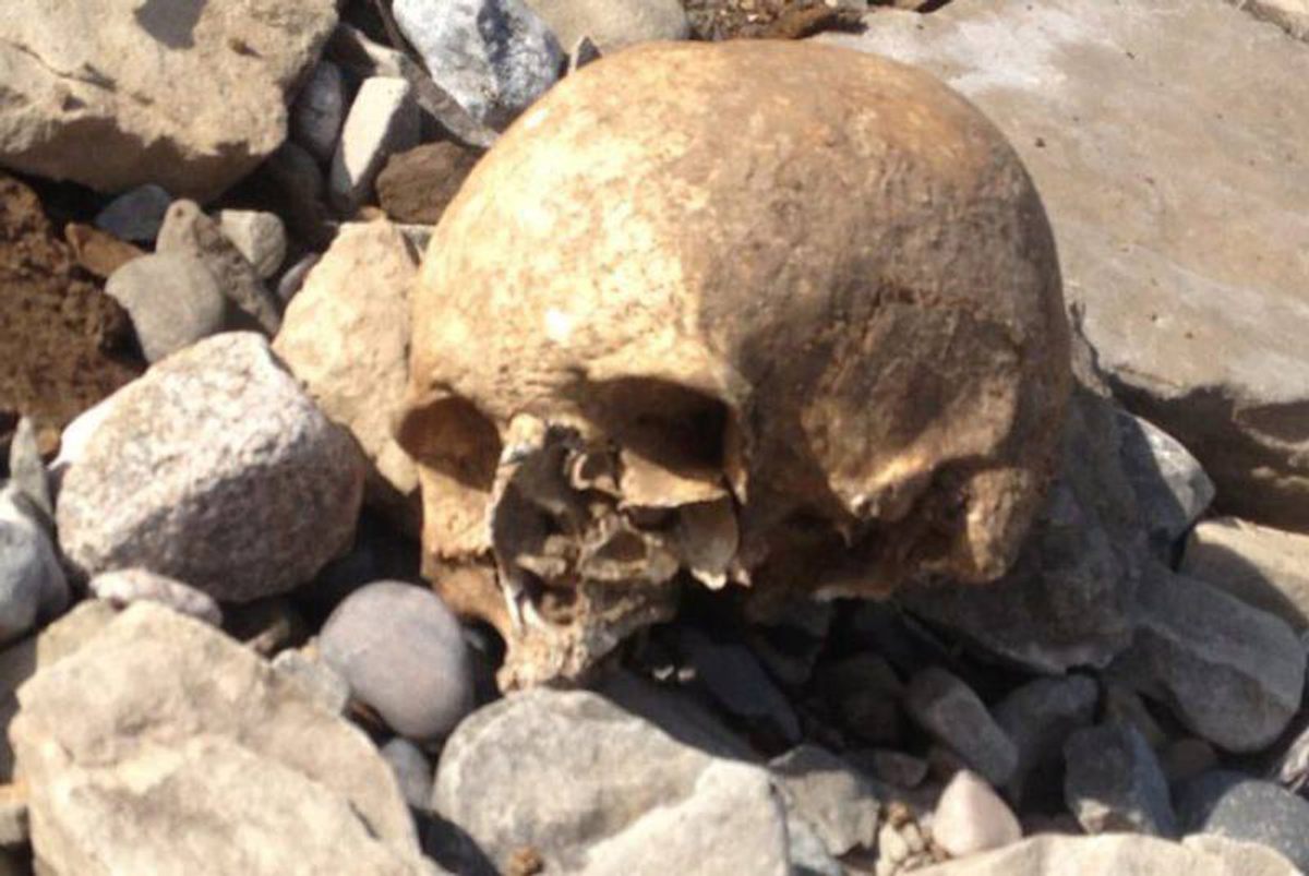 Free of its grave, a skull rests on rocks near a 200-year-old cemetery in Cape Breton, Nova Scotia. "We have a long-standing battle with the sea,” says caretaker Hector Murphy.