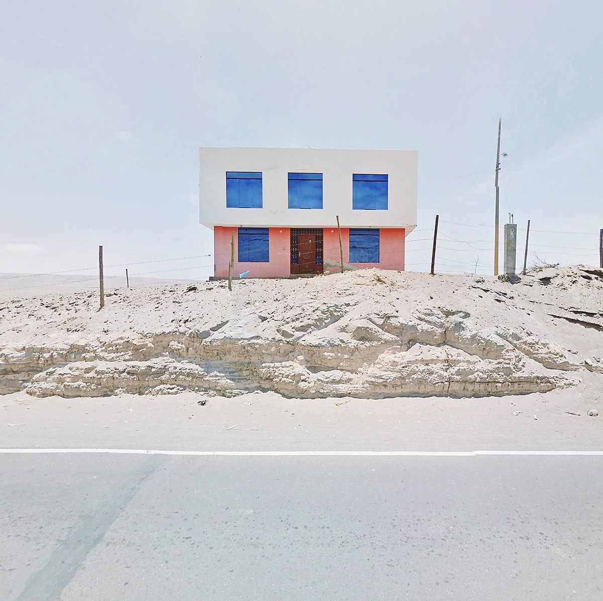Kenny is drawn to stark landscapes, sometimes with pops of color, such as this house in Peru.
