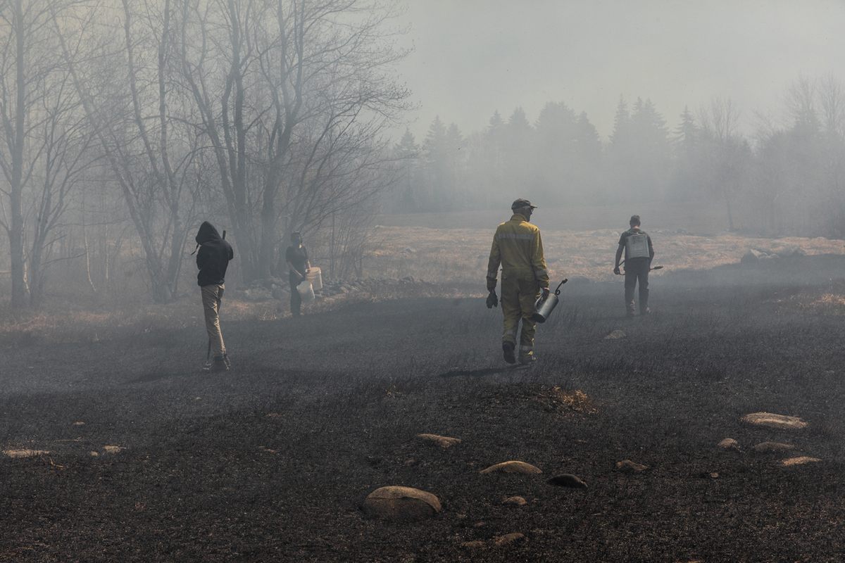 Nicolas Lindholm and his crew walks through the burnt area.
