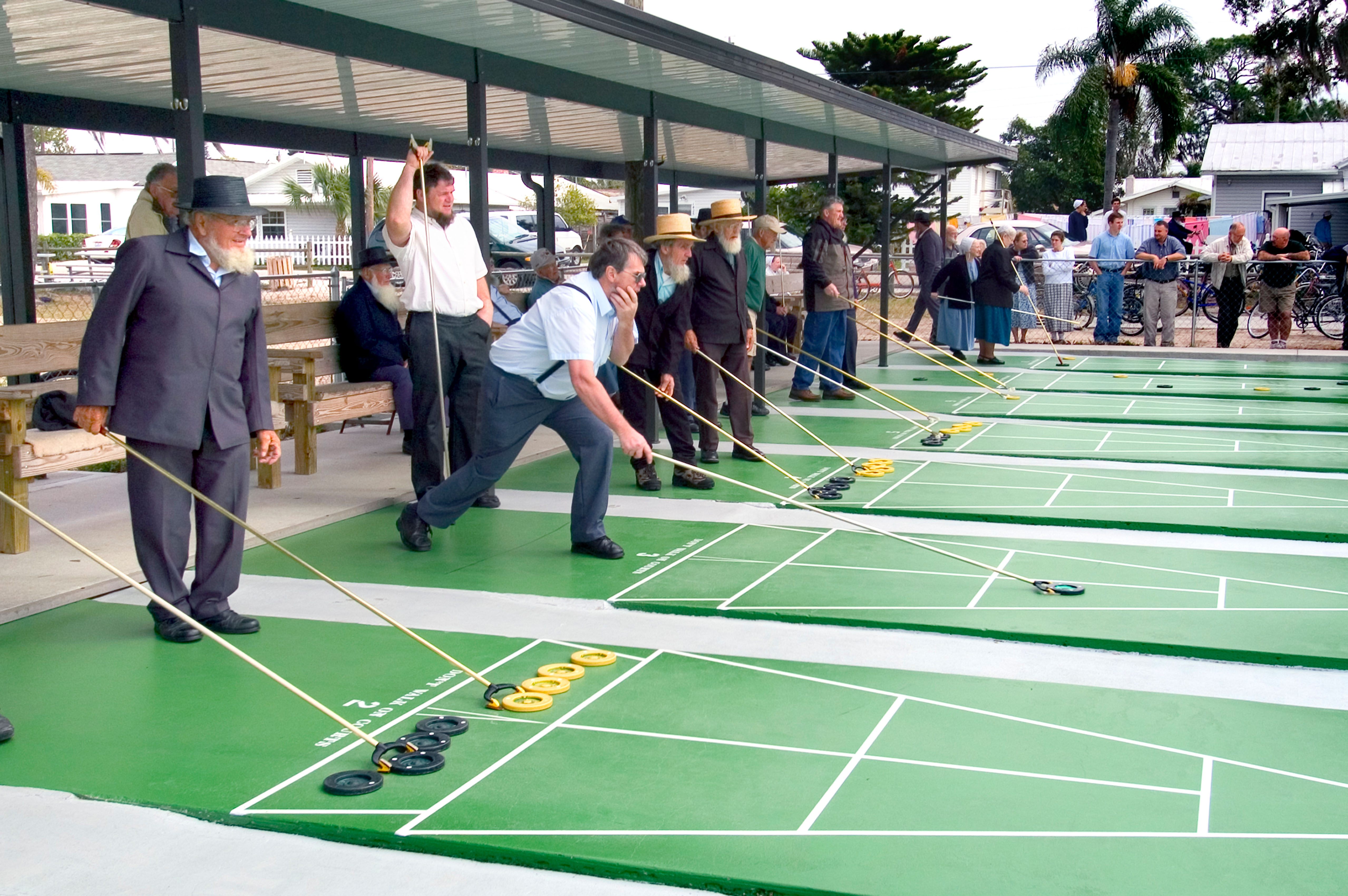 Amish men and women playing shuffleboard in Pinecraft.