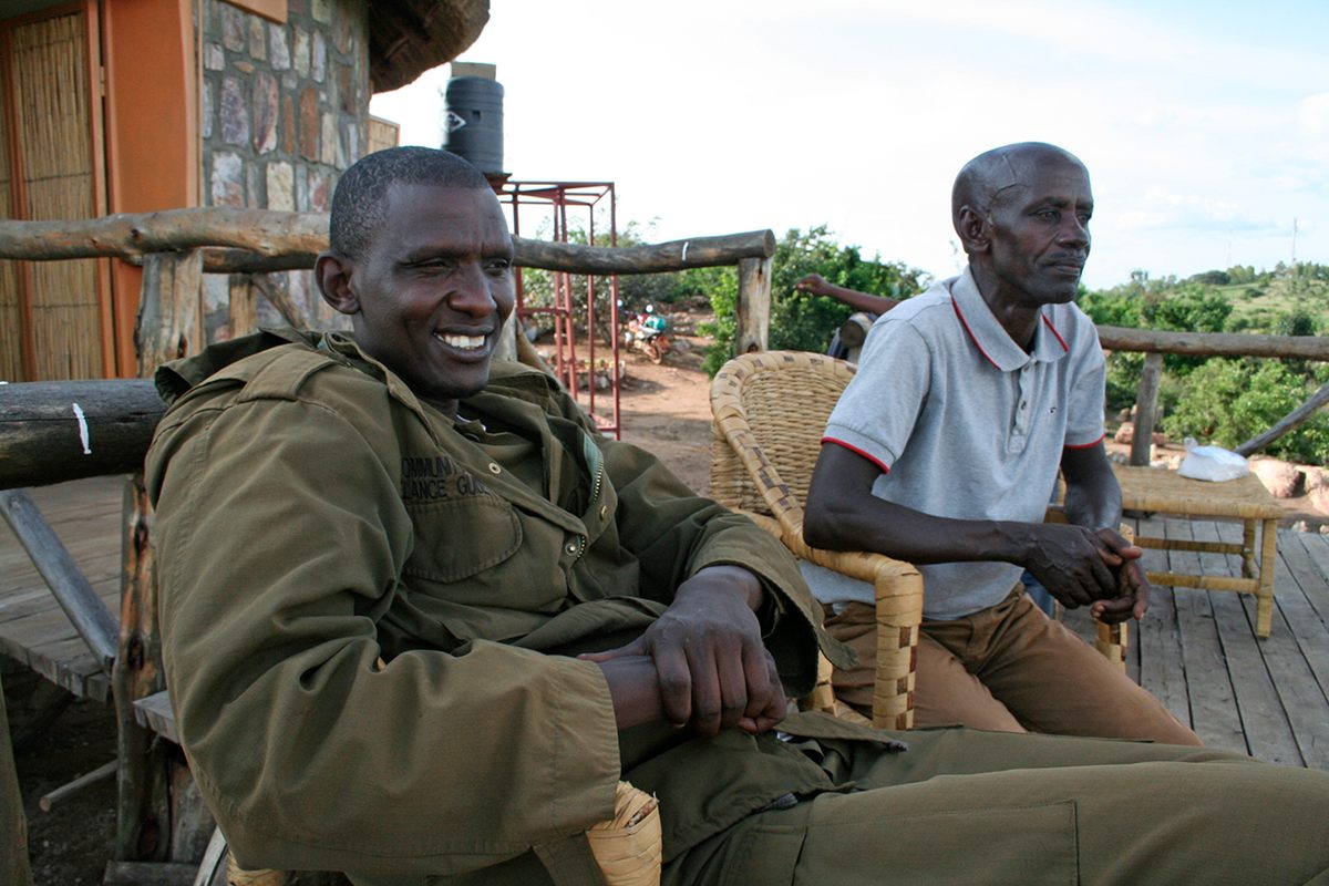 A park guide (left) and Emmanuel Kalisa (right), a local herder.