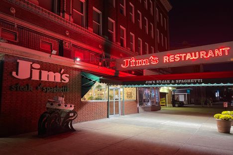 The exterior of Jim's restaurant, at night.