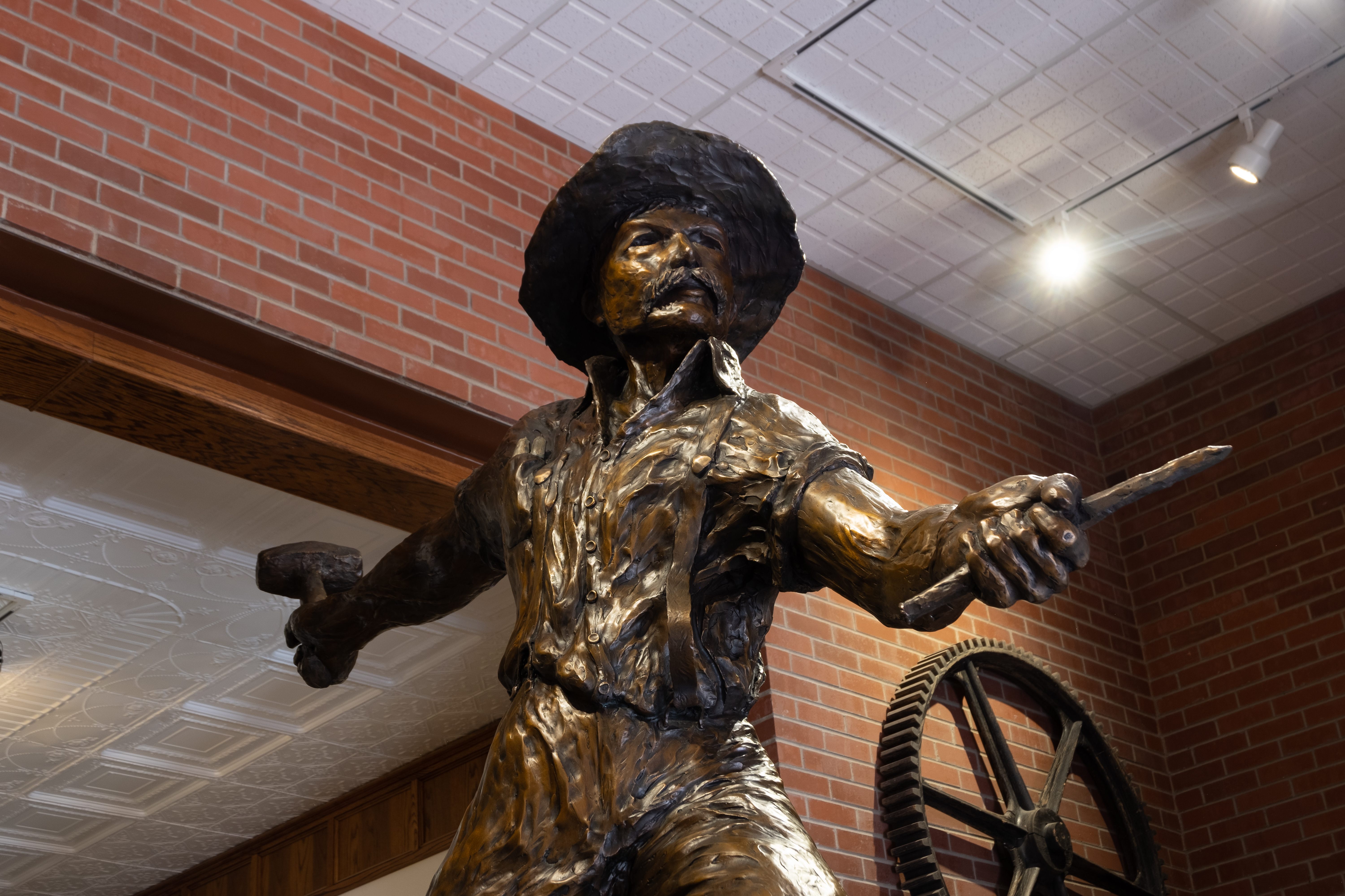  Miners like this one, statuized in the Mining Hall of Fame, were encouraged to head west with beans, flour, and at least 80 pounds of bacon.