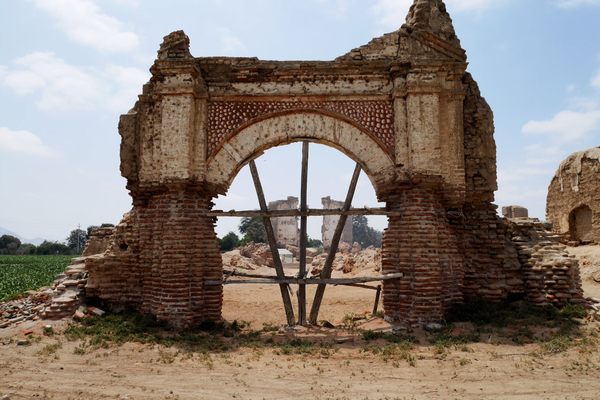 Church ruin layered with centuries of destruction in the distance