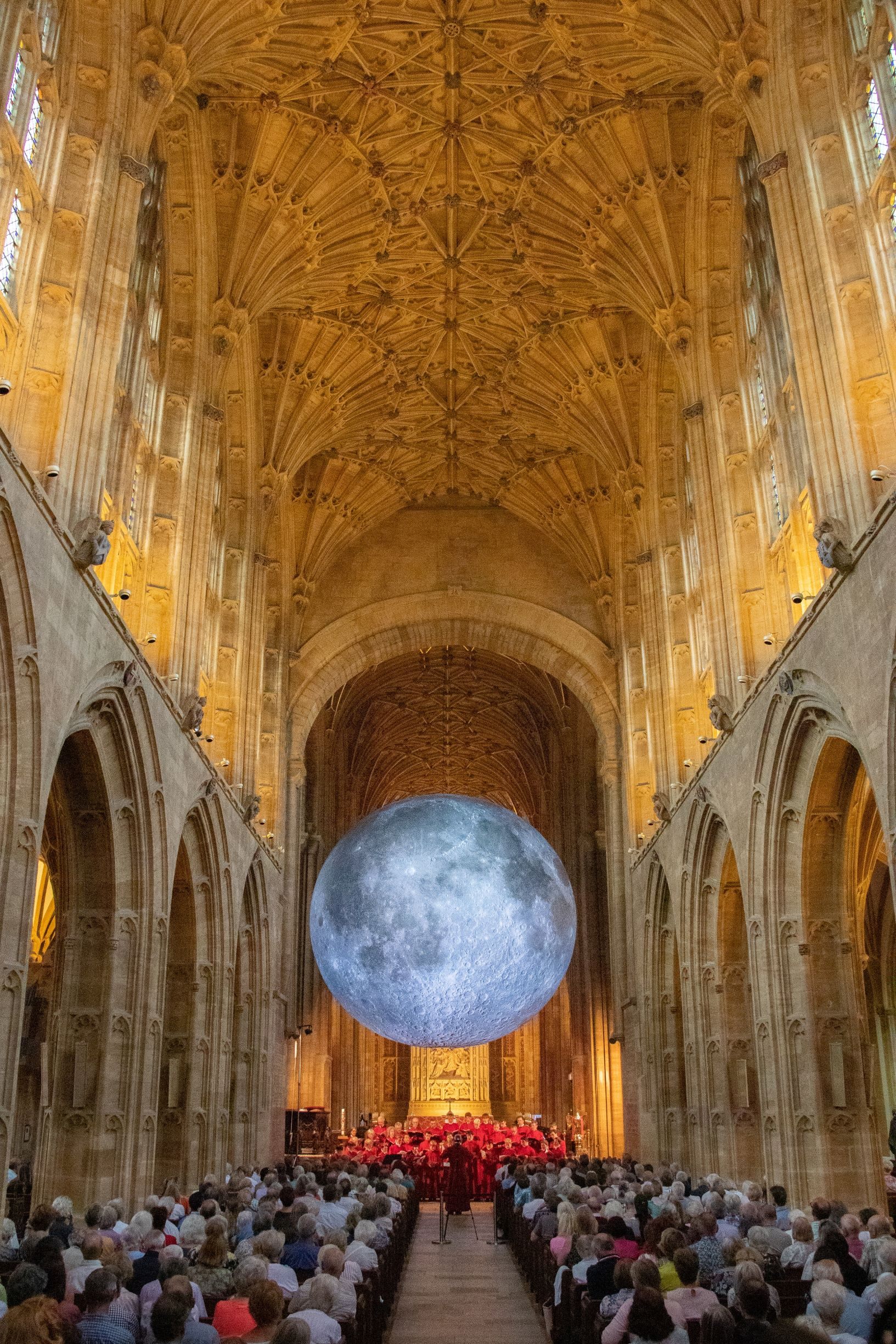 The moon hung low over the crowd gathered at Sherborne Abbey.