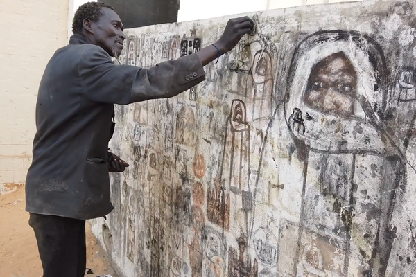 Pape Diop, shown here working in Dakar in 2018, was one of the most prolific street artists of Bamba images. 