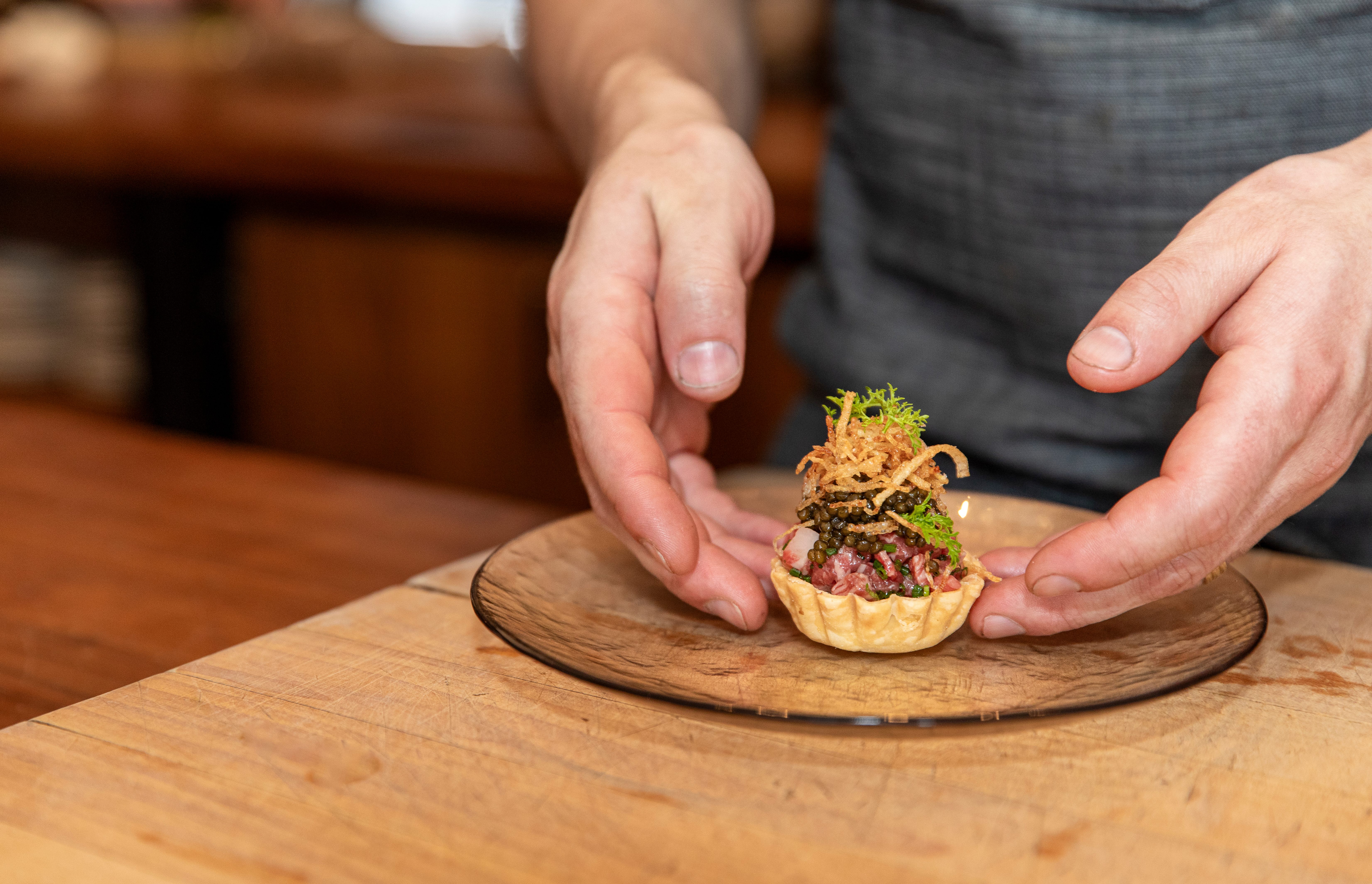 At Beckon, chefs prepare eight courses right in front of the diners. Here, dinner is the show. 