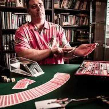 Conjurer Jason England teaches a card trick.