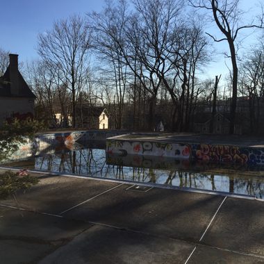 Abandoned pool with Gate House in the distance