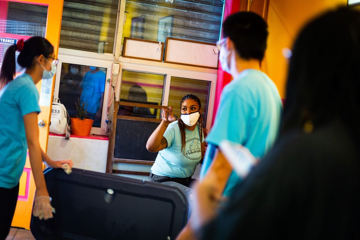 Tasha Palacio, center, oversees Fishadelphia's weekly packing of seafood and its youth development program.