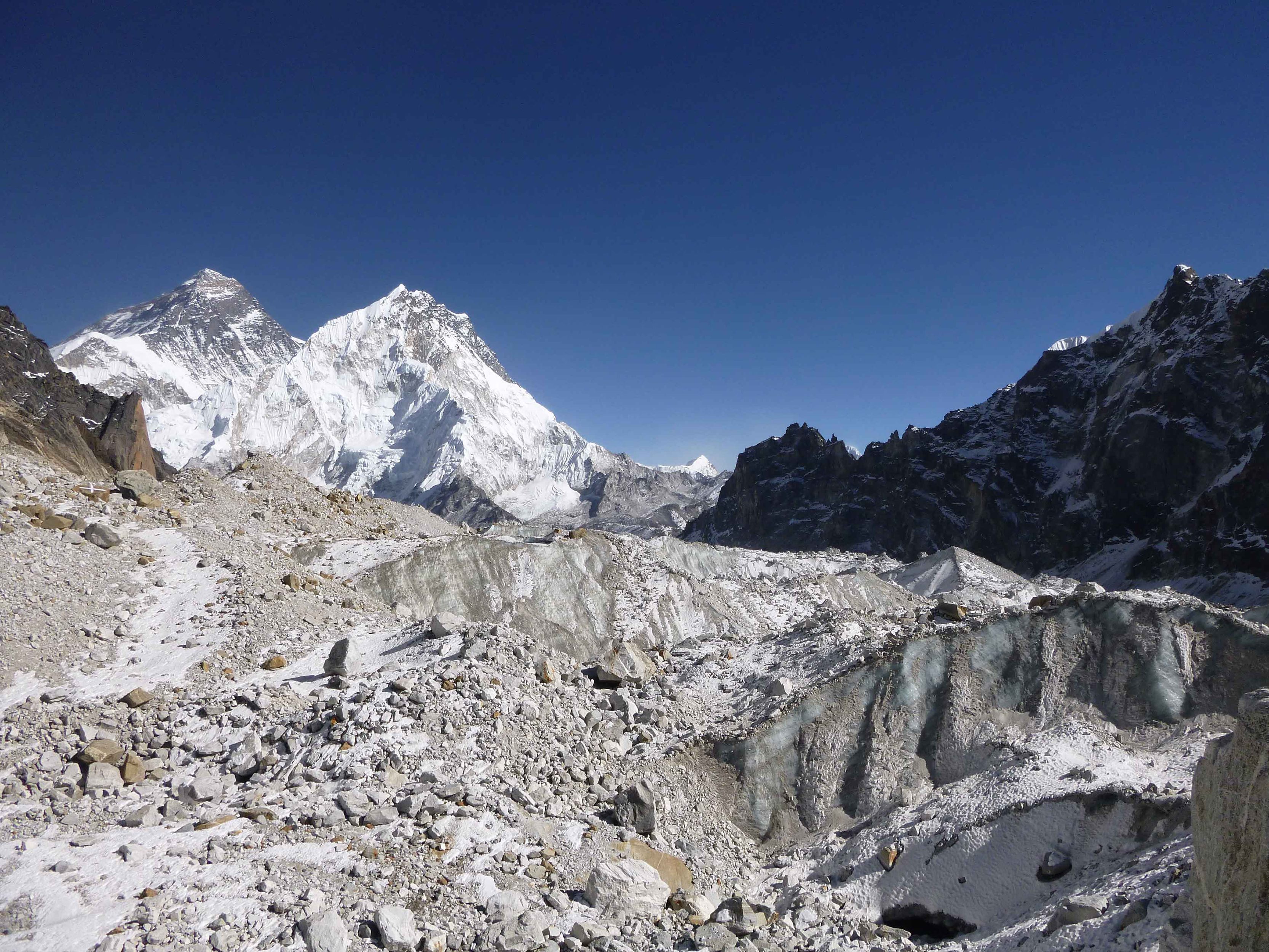 The Changri Nup glacier is covered with rock debris and glacial ice. That's the peak of Mount Everest poking up in the background.