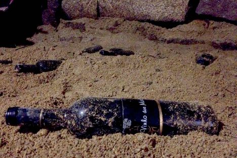 A half-buried bottle of wine of the dead.