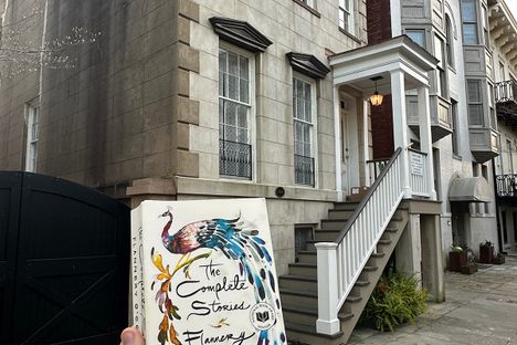 Presenting Flannery O'Connor's collection of short stories in front of her childhood home.