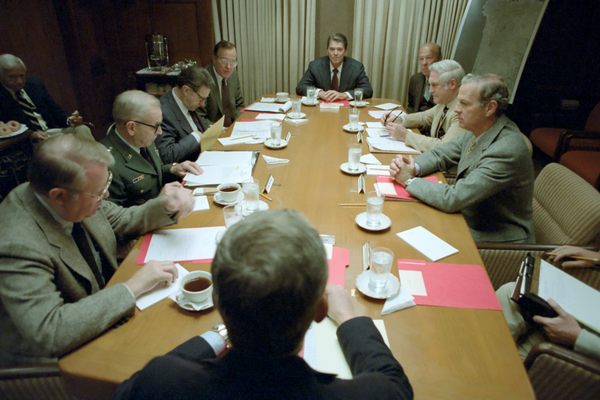 President Ronald Reagan with Caspar Weinberger, George Bush, Ed Meese, John Vessey, James Baker, Robert Mcfarlane, and George Shultz in a National Security Planning Group Meeting in The Situation Room, 10/23/1983
