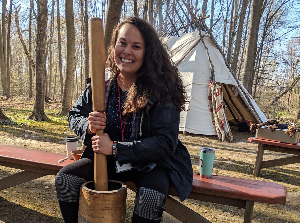 Taelor Barton at the 2019 Intertribal Food Summit preparing hickory nuts for kanuchi, a traditional Southeastern dish her grandmother taught her.