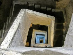 A staircase excavated from the tuff leads to a depth of 120 feet (40 meters).