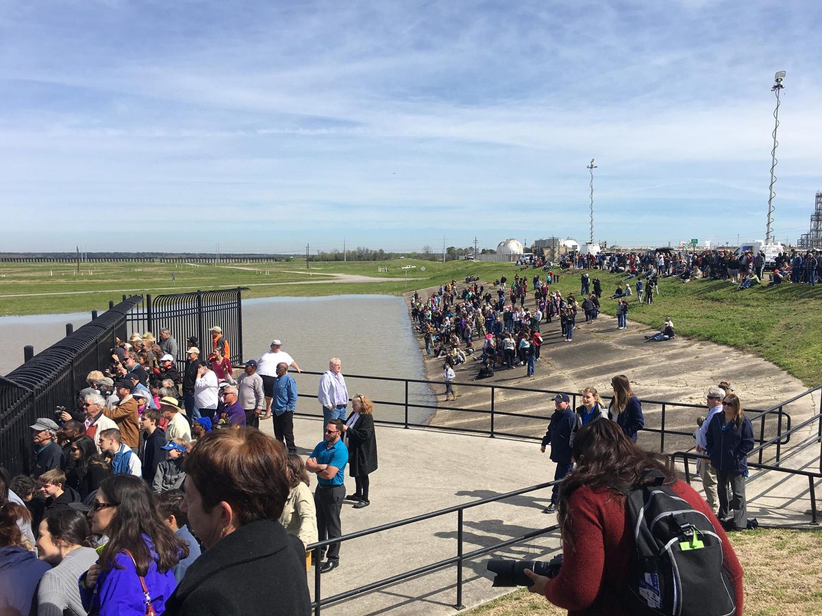 Crowds of people watch as the Bonnet Carre Spillway diverts water from the Mississippi River toward Lake Pontchartrain.