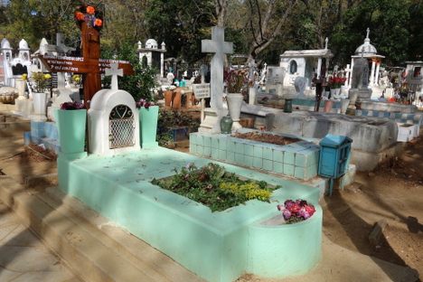 Two foam-green crypts with planters.