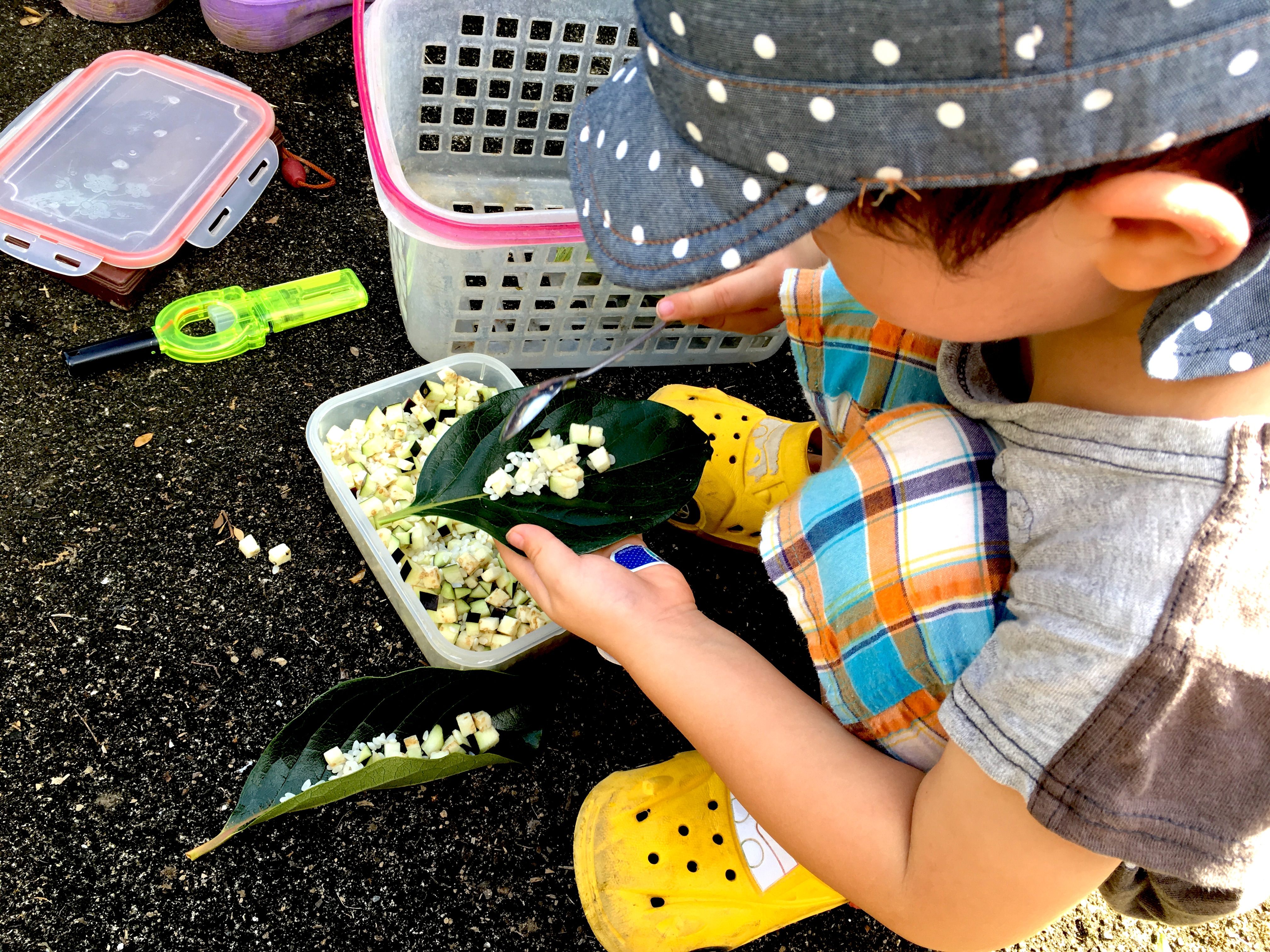 Hibito prepares the mizunoko offering from uncooked white rice and eggplant.