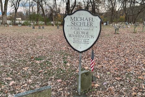 A simple plaque and stone marks the grave of Washington's bodyguard.