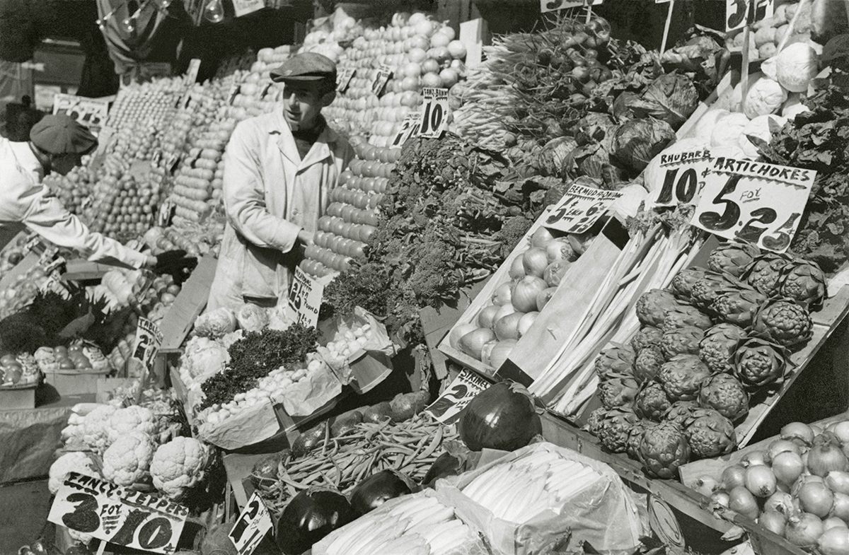 A vegetable seller at Fulton Street market in New York City, 1934.