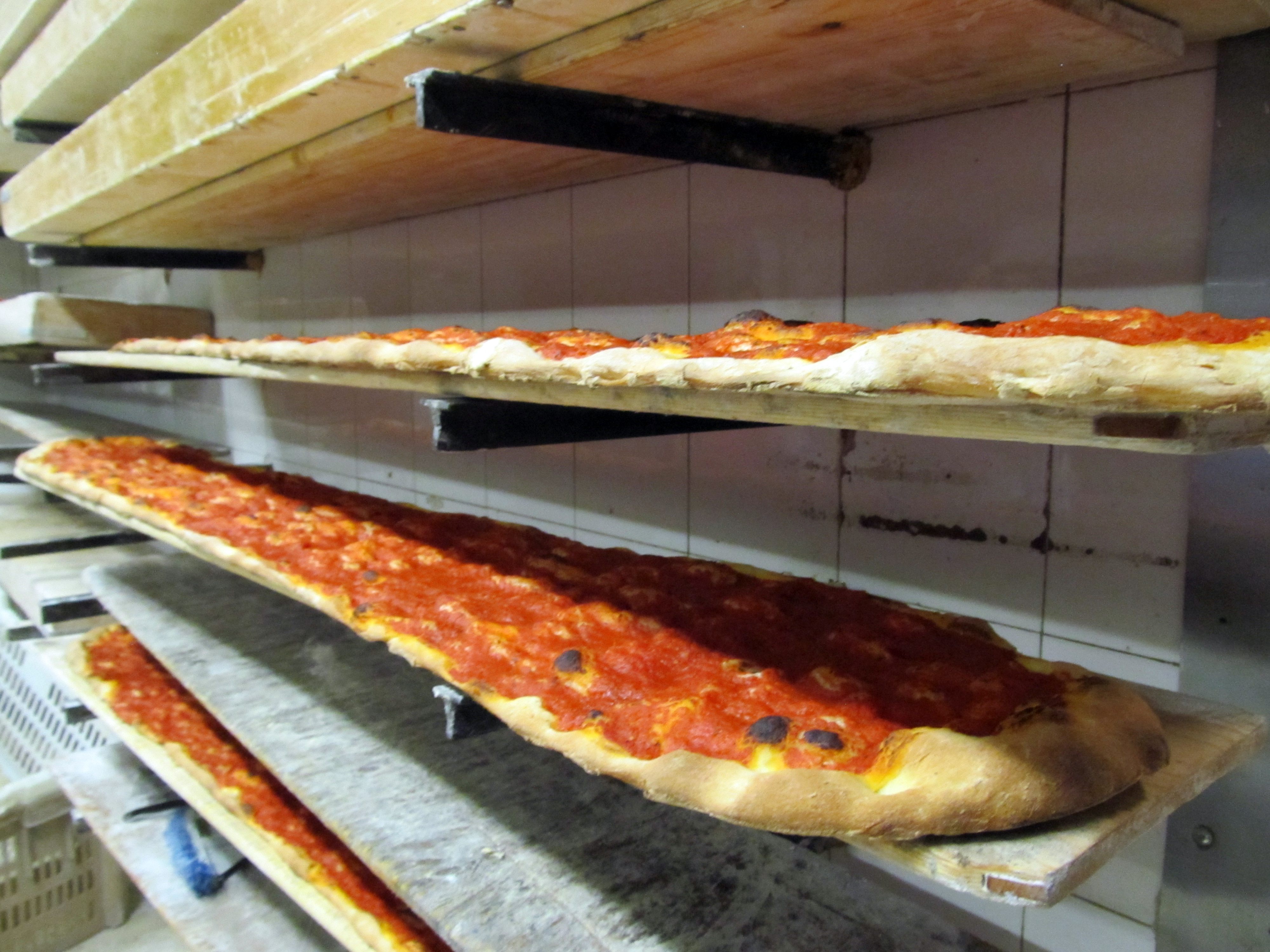 Long pizza pictured at Rome's La Renella. These pies are baked in six-foot pieces.