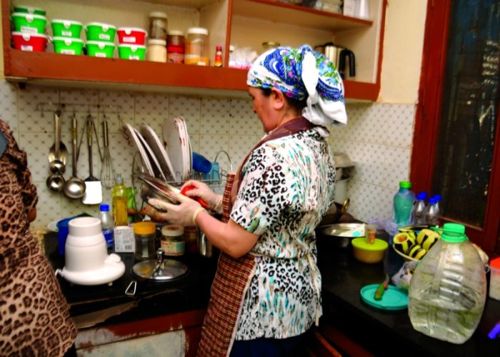 Women cook in their "Living Lab," an apartment in Khirki Extension, New Delhi. 