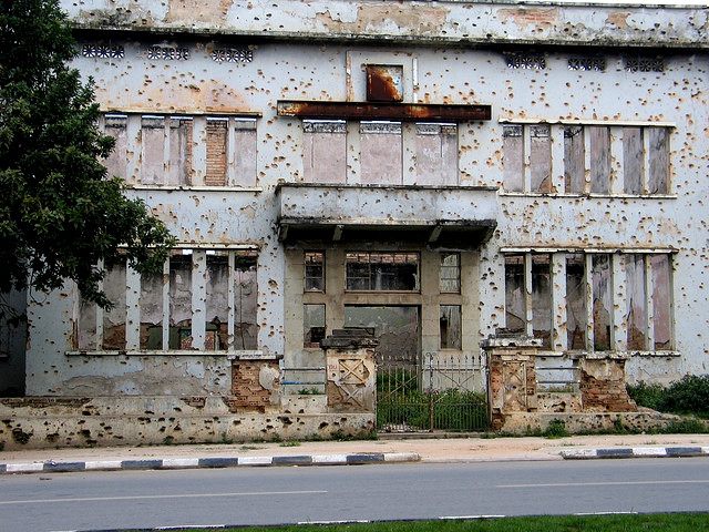 A building in Huambo covered in bullet holes from the Angolan civil war.