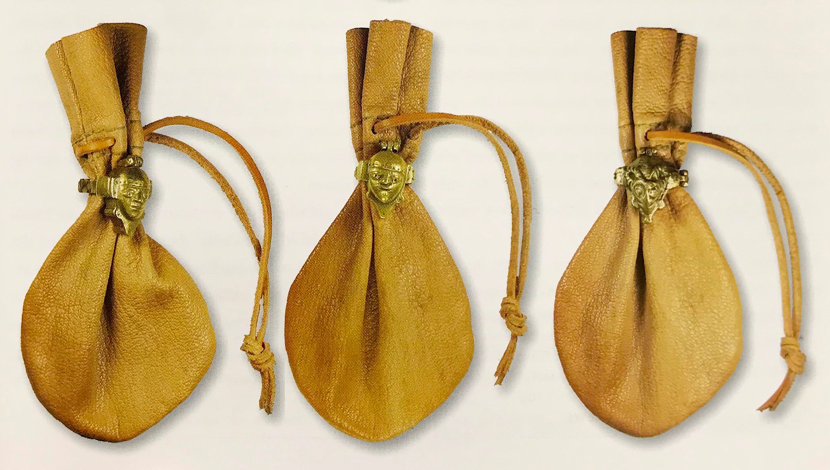 Replica puzzle locks and coin pouches give us an idea of how the locks would have looked in their original use.