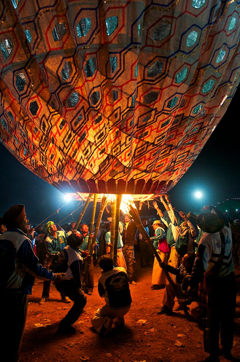 Team members work together to set a balloon afloat during the Tazaungdaing Festival of Lights in November 2015.