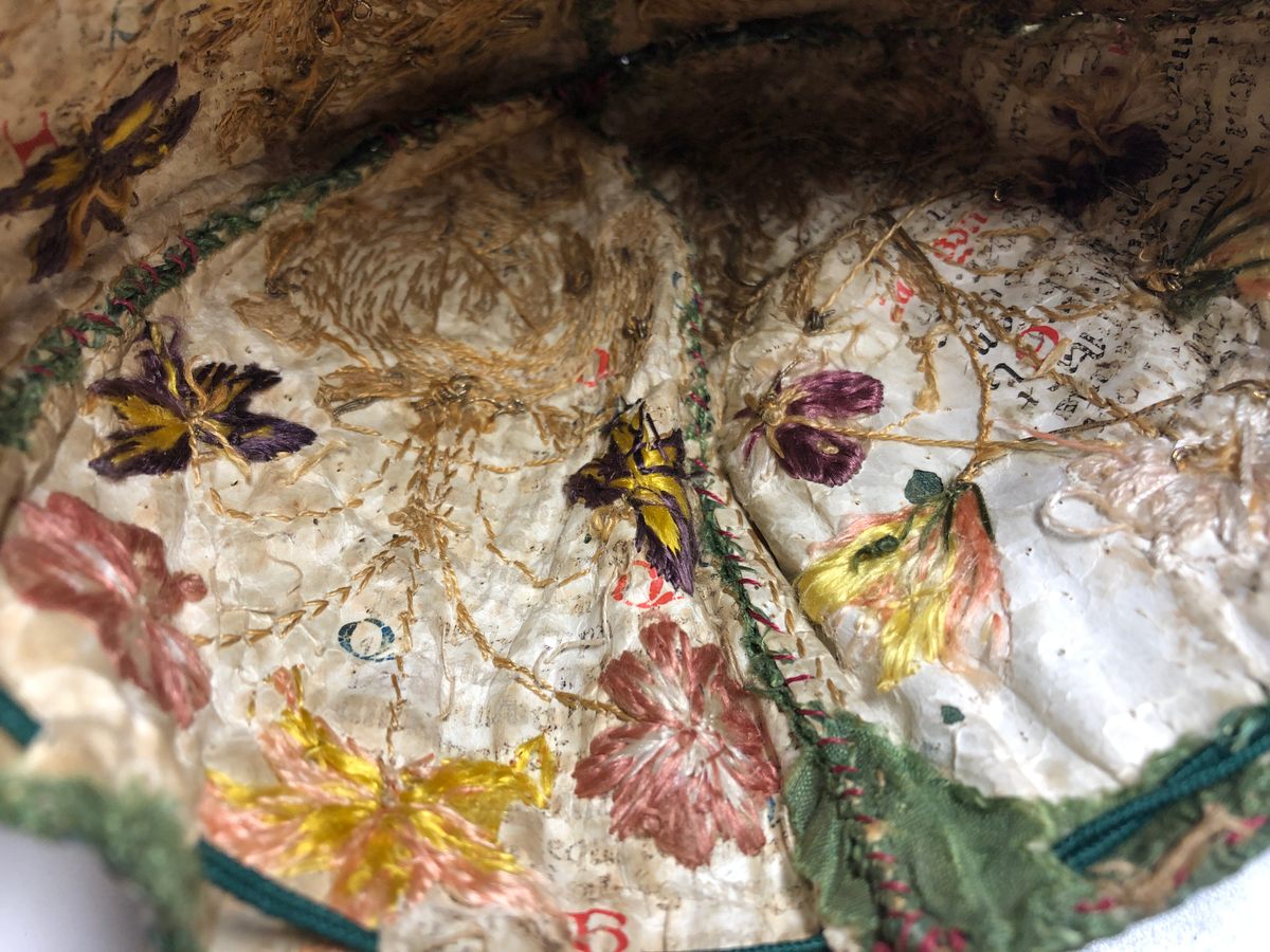 Inside, the purse holds fragments of faded text.