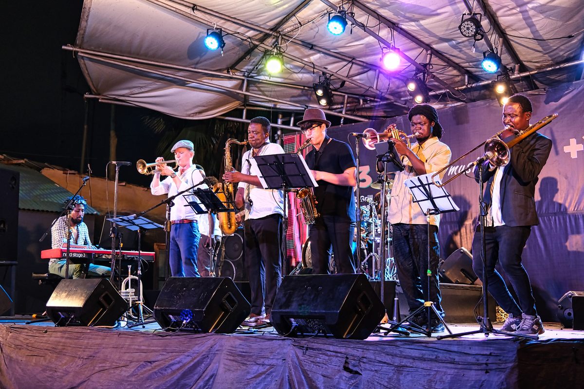 More than 60 years after Armstrong's visit, pianist Victor Dey Jr. (left) has witnessed a resurgence in interest in jazz. Here, he and his band perform for a crowd at +233.
