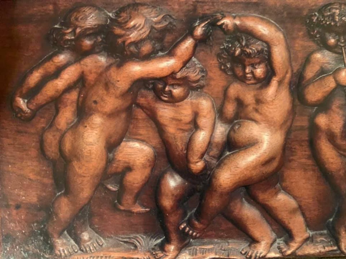 Details of the cherubs carved into the piano.