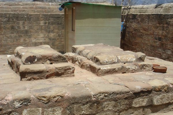 Two stone tombs on a raised stone platform