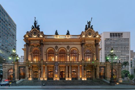 The exterior of a large, elaborate theatre at dusk