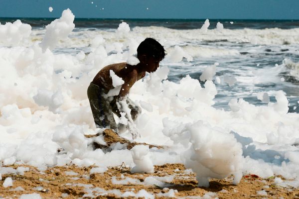 At Marina Beach in Chennai, visitors waded into the foam.