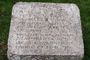 The memorial stone text, which is difficult to read.