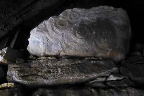 Rock art on stone by entrance.
