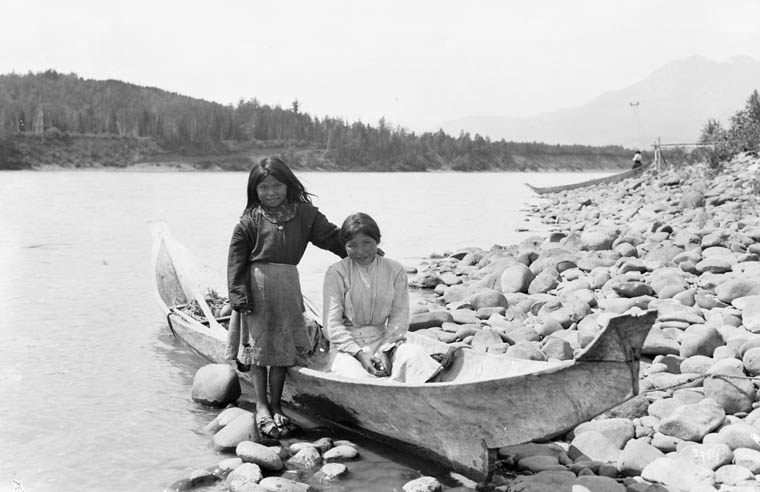 Gitxsan First Nation girls in a dugout canoe on the Skeena River. Skeena salmon are a vital food source for many First Nations Canadian.