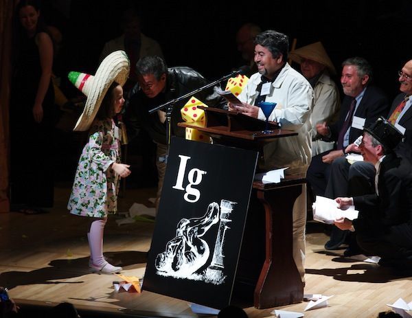 Chemistry Ig Nobel winner Javier Morales gets interrupted by Miss Sweetie Poo in 2009. Morales and his cohort discovered a way to turn tequila into diamonds. (Photo: ) 