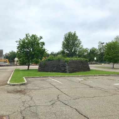 The gravesite among the asphalt.