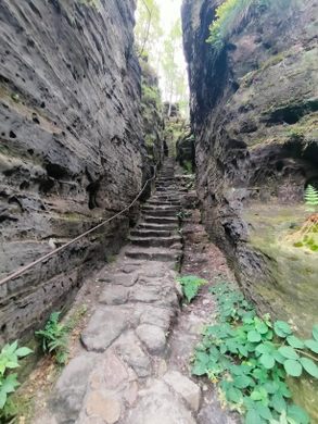 stone steps lead up between two towering rock faces.