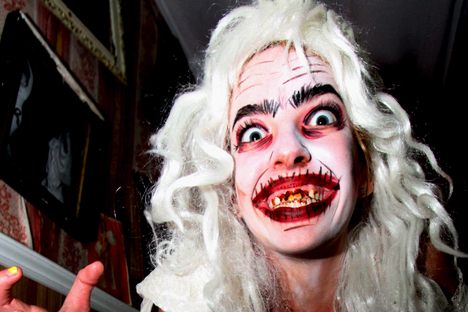In a Toronto haunted house, a female actor poses for a photo. 