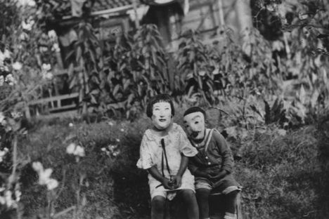 Two siblings—Aiko and her brother Isamu—pose in their masks in the yard of their family home on Los Feliz Boulevard near Griffith Park, where their parents ran a flower nursery. This photo, taken in 1925, was collected as part of Shades of L.A., an outreach program the library conducted in the 1990s to diversify its photo collection.
