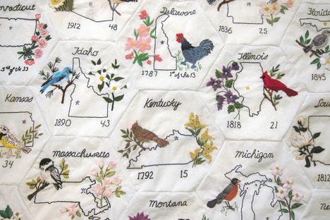 Detail shot of Rita's quilt. The hexagons are decorated with the outlines of the 50 U.S. states, along with their official birds and animals.
